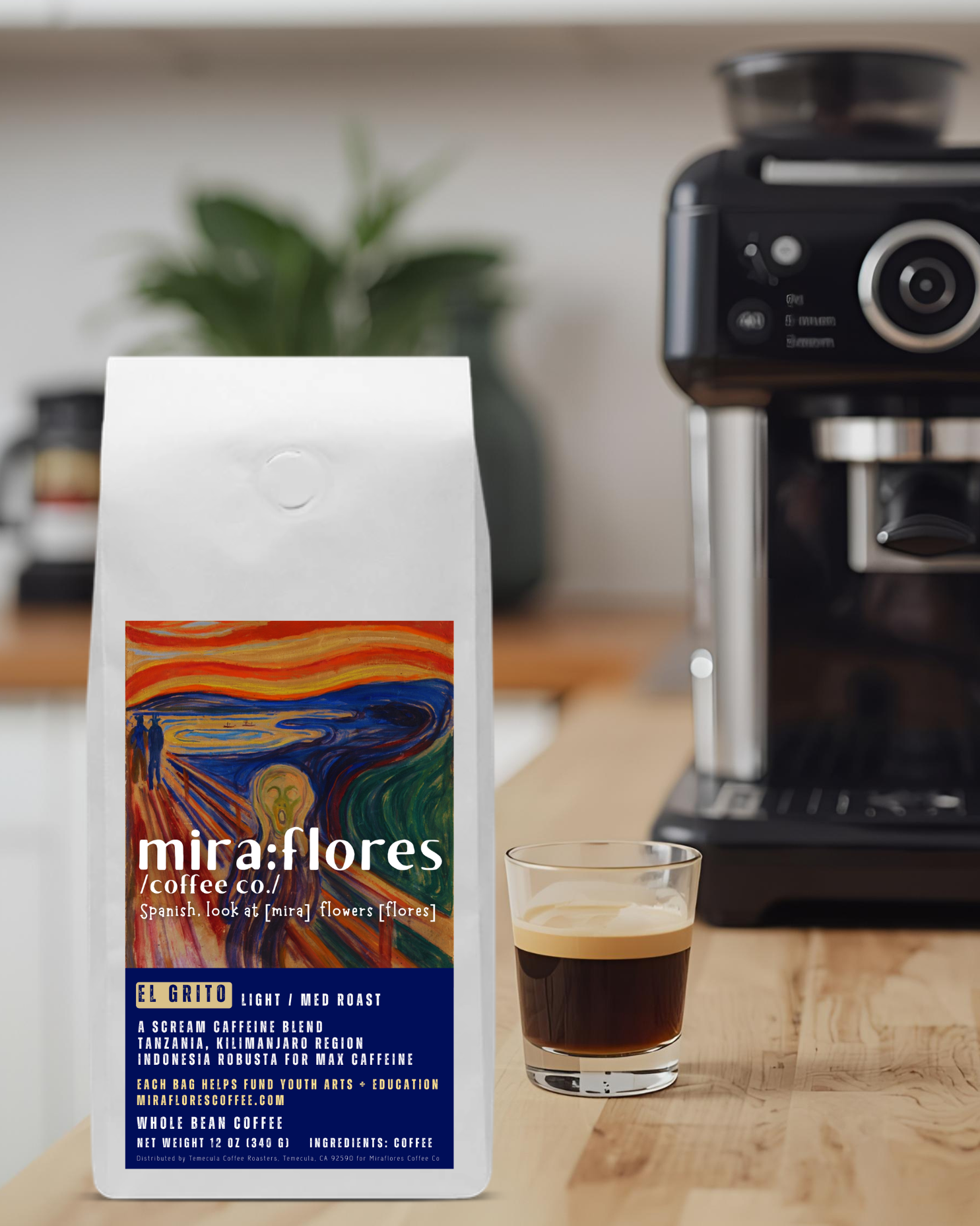 Specialty coffee bag for Max Caffeine light roast with miraflores branding and art masterpiece The Scream by Edward Munch, set on a counter with a shot of espresso and a coffee maker
