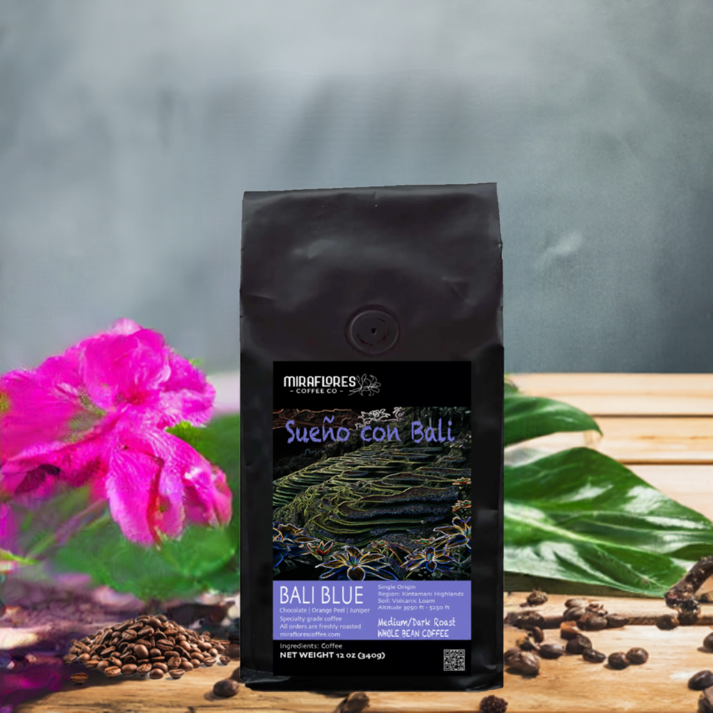 Bali Blue Single Origin Coffee Bag for Miraflores Coffee with pink flowers over a wooden crate
