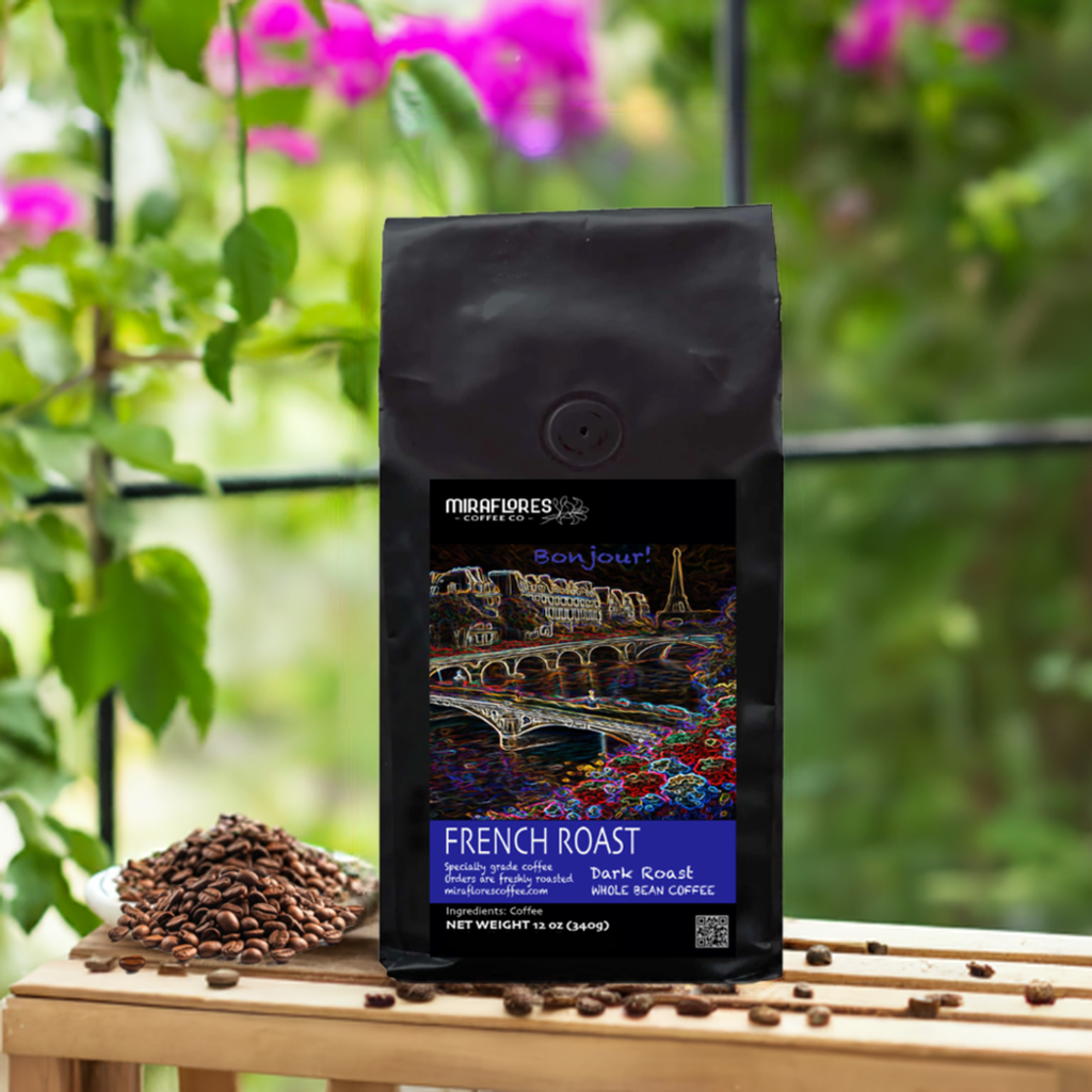 Bag of French Roast coffee from Miraflores Coffee Co. showing art of the seine and eiffel tower, bag is set alongside roasted coffee beans, on a wooden table, by a window with plants and pink flowers